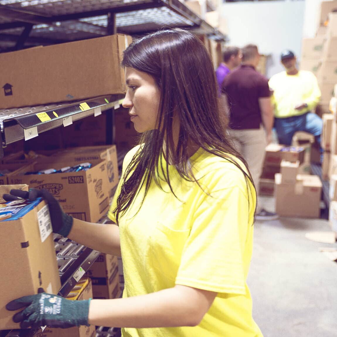 Canteen employee in warehouse, bulk snacking, sustainability practices