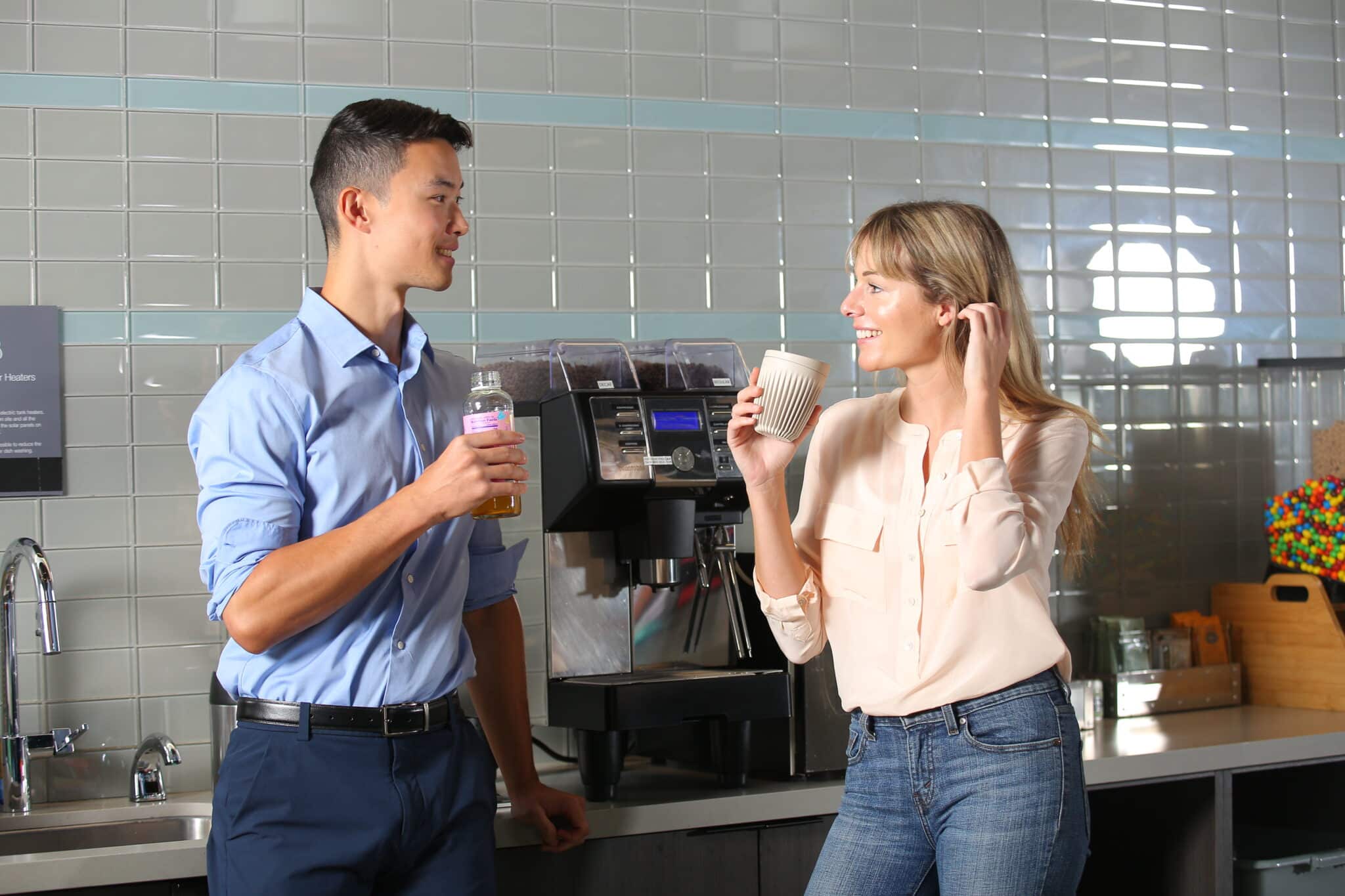 Two people drinking coffee in a Canteen breakroom