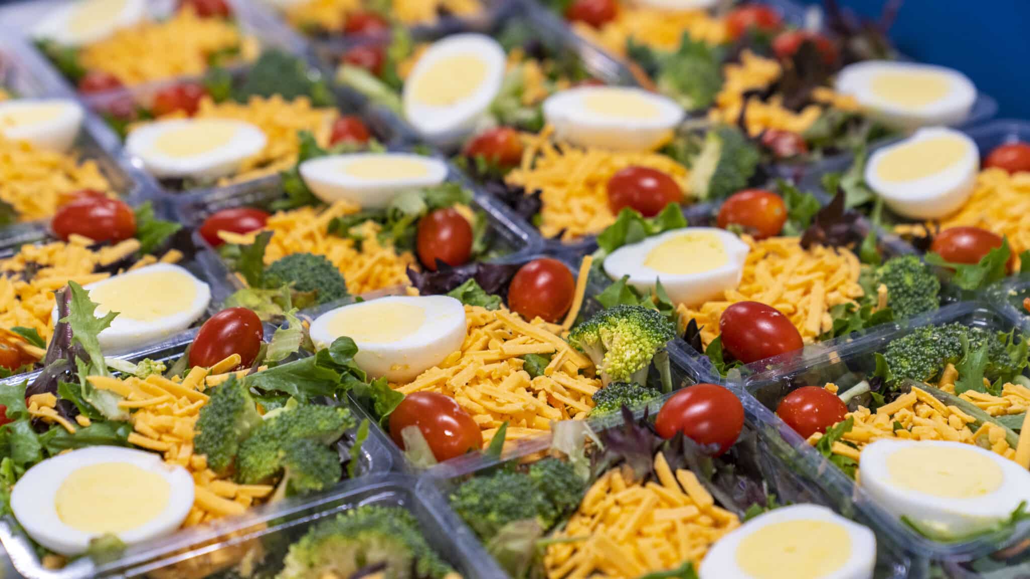 Garden salad being packaged, grab-and-go meals, fresh food for workplaces