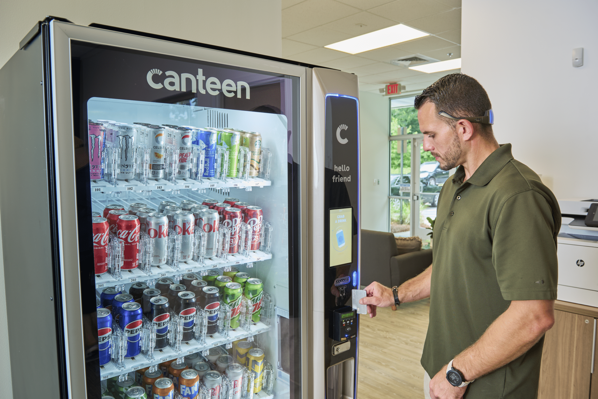 Man at a soda vending machine, beverage vending, self-serve technology