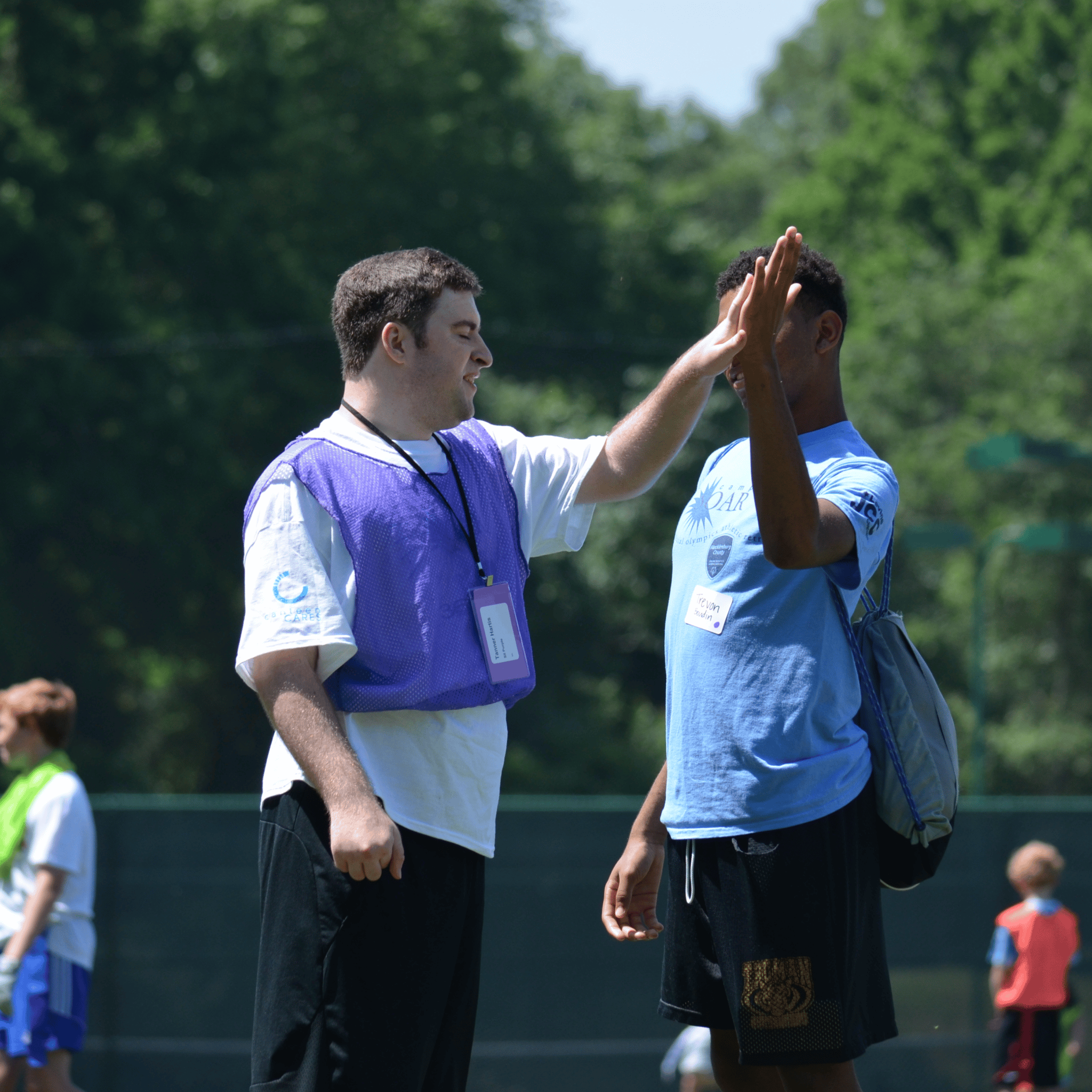 Camp SOAR Camp SOAR athlete and volunteer high fiving, Special Olympics Athletic Retreat, Outdoor Sports
