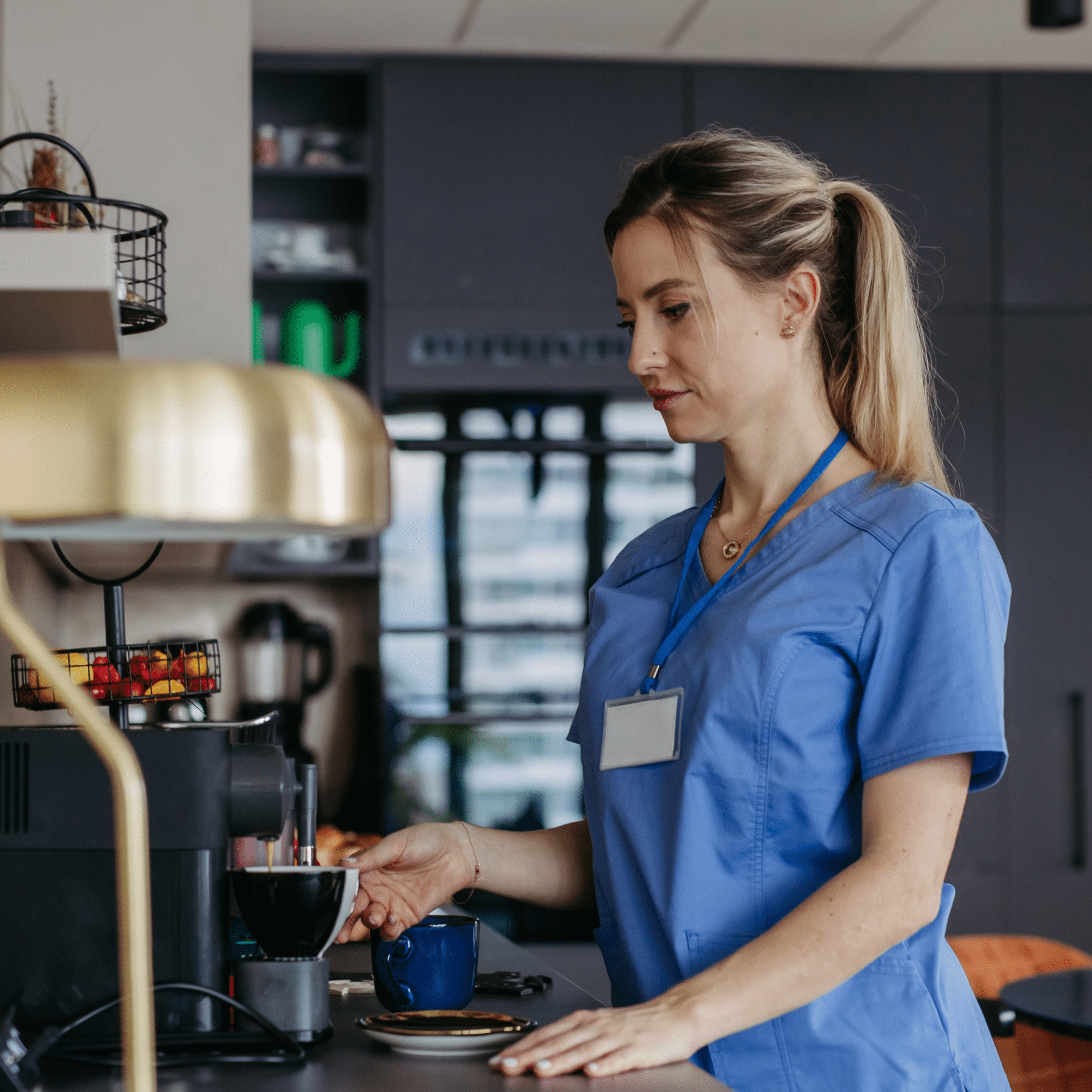 Female nurse getting coffee and snacks in a breakroom