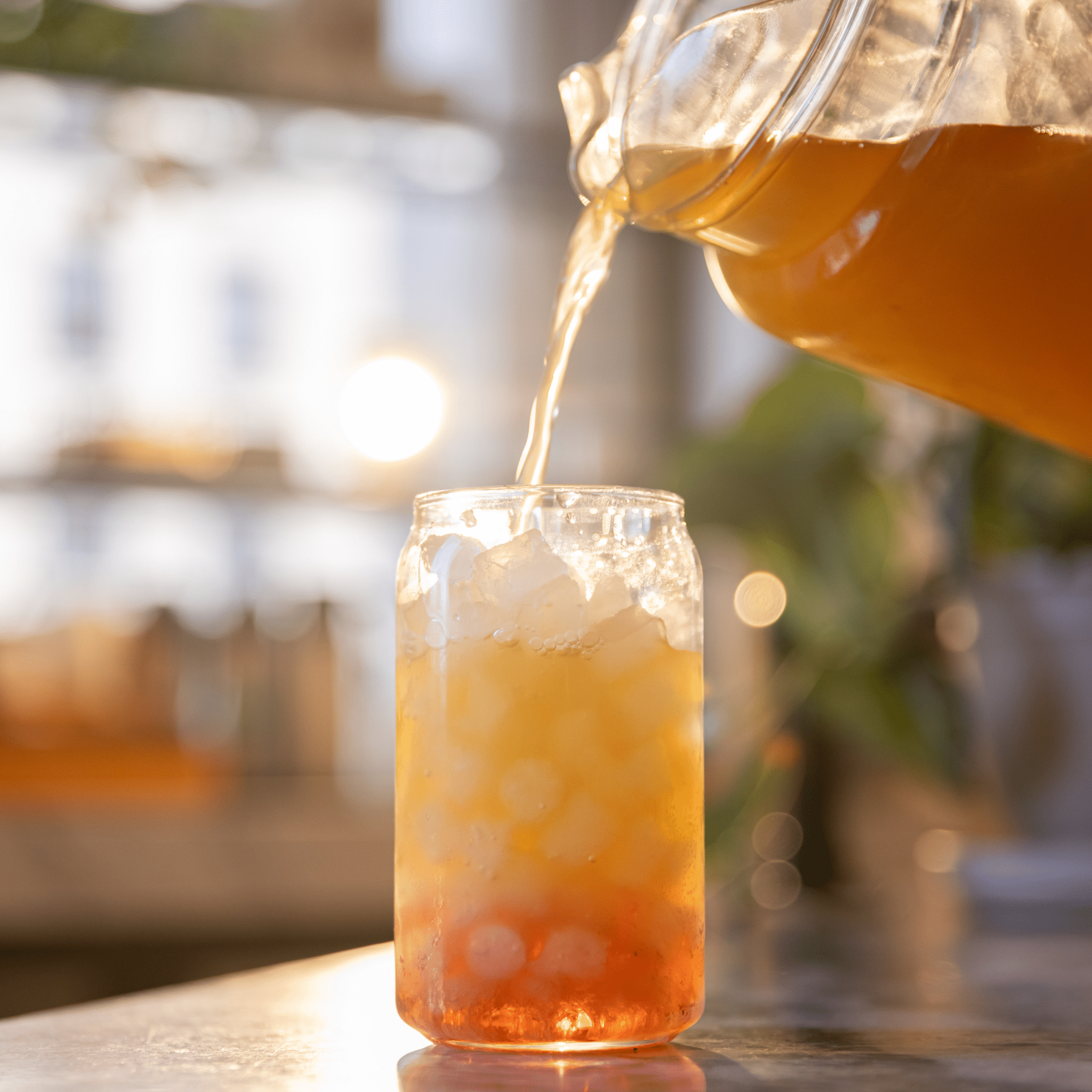 Iced Tea Pour Iced tea pour into glass cup, pouring tea