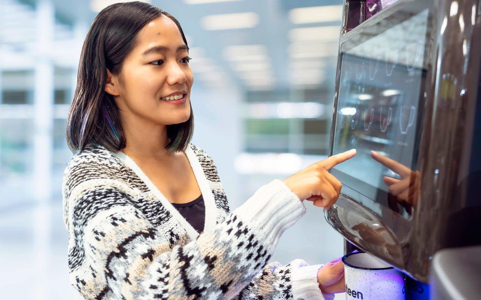 Woman Making Single Serve Coffee Woman using touchscreen coffee machine, Canteen coffee services, single serve coffee, office coffee and tea