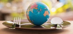 An image of a globe resting on a dining plate
