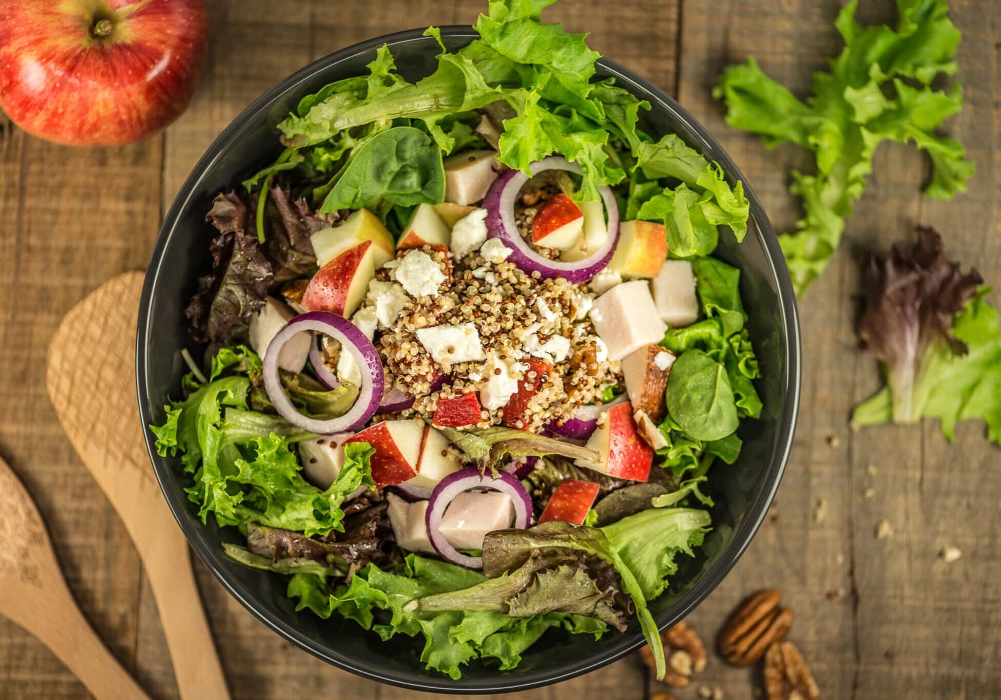 Strawberry Salad Strawberry, nut, onion, and cheese salad, wooden spoons, salad in bowl