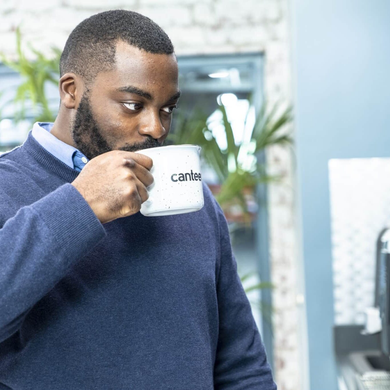 Man in office drinking Canteen coffee