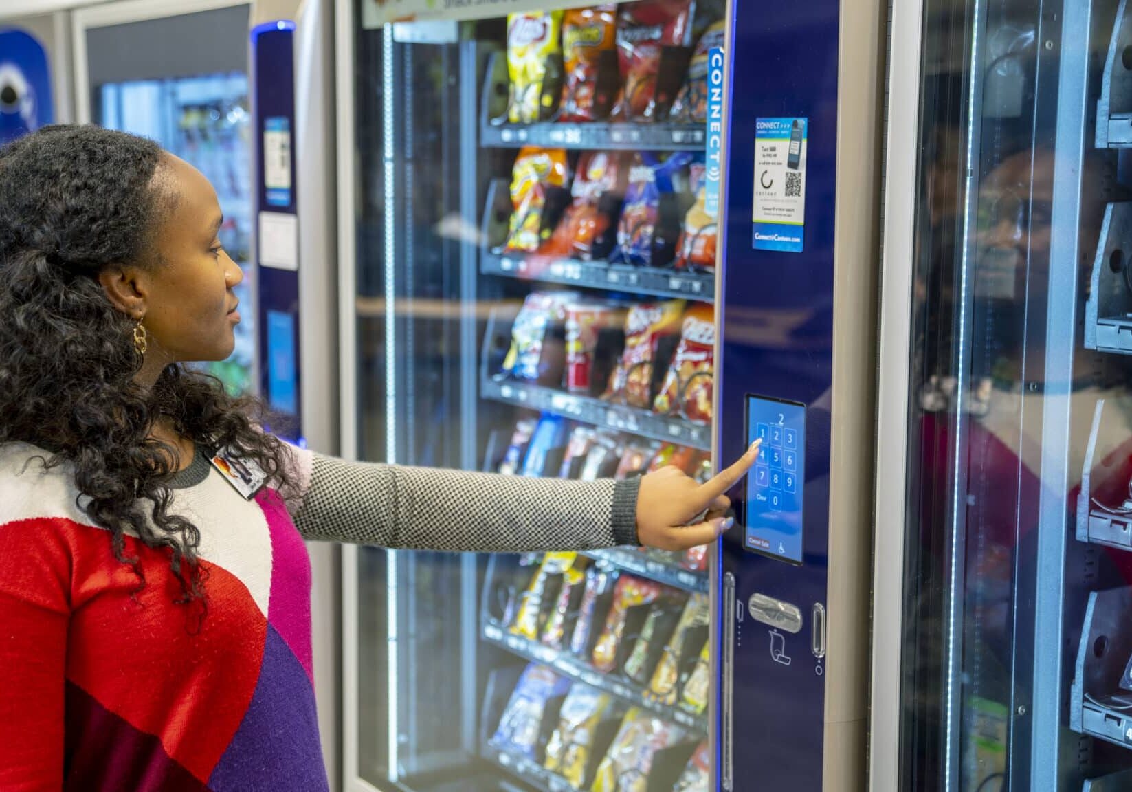 Woman Choosing Snack at Vending Machine Worker choosing snacks at a vending machine, innovative vending technology, variety of product options