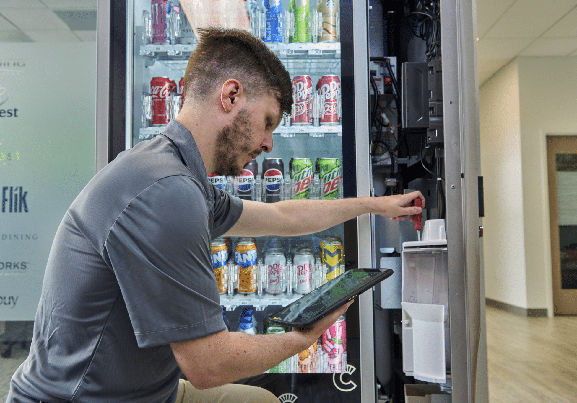 Canteen Employee Vending Maintenance Canteen employee fixing a vending machine, vending technology maintenance, reliable vending service
