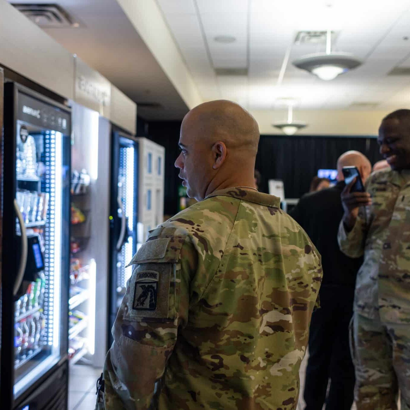 Military Personnel at a Vending Machine Military personnel at a vending machine, contemplating at a vending machine