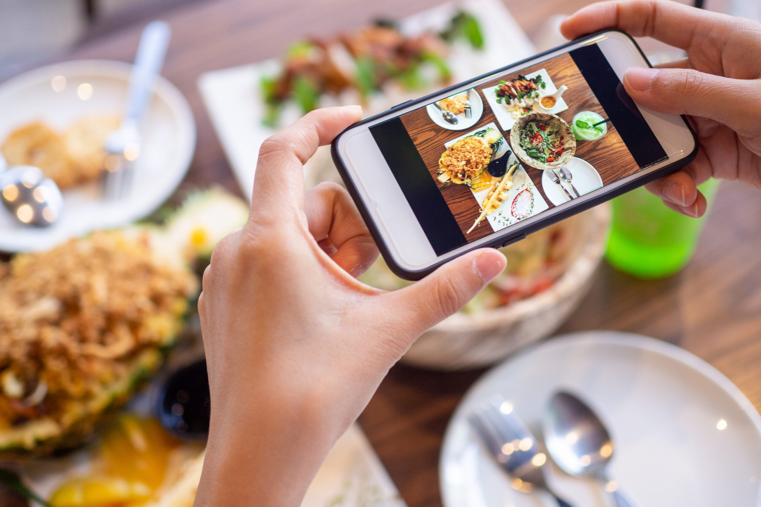 Person taking picture of food for social media