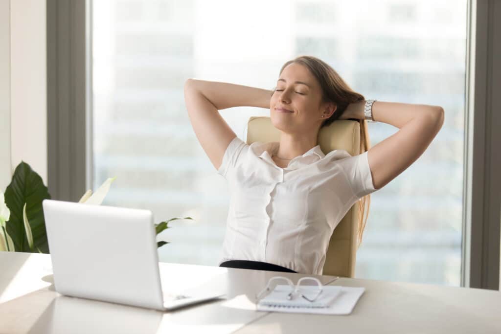 Woman relaxing at work desk
